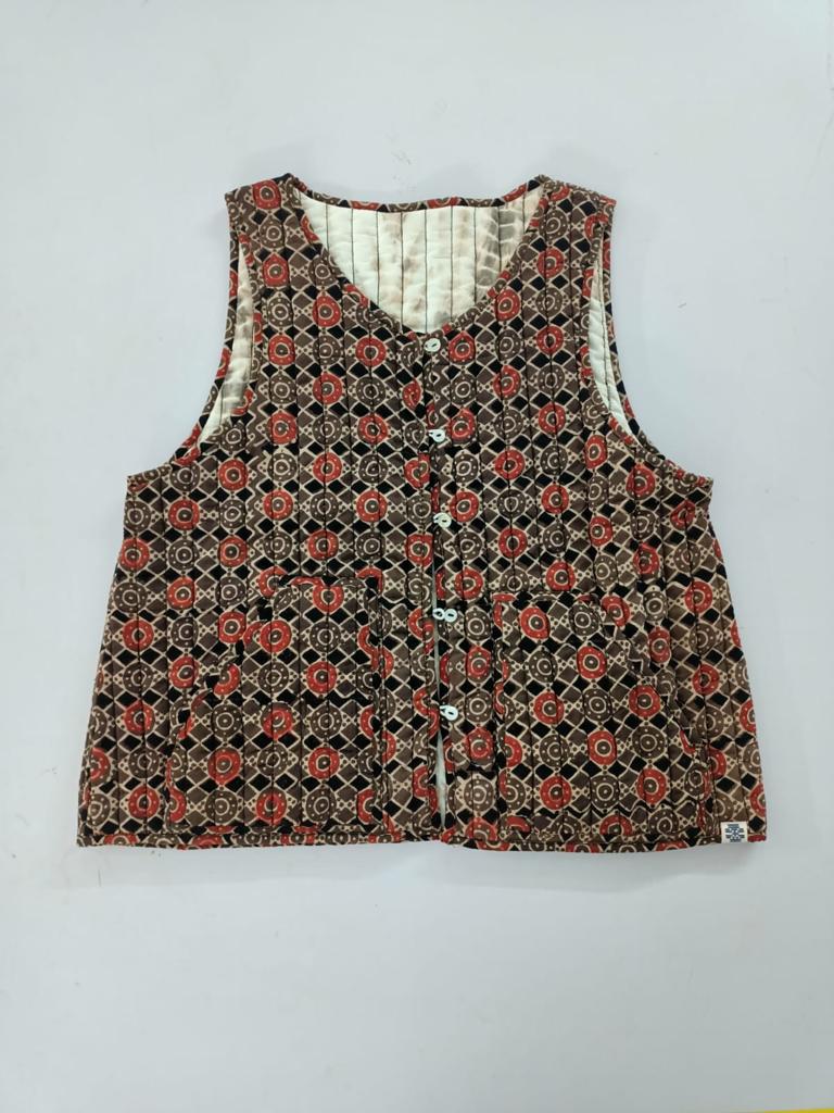 Brown reversible ajrakh and natural dye shibori sleeveless quilted cotton jacket.