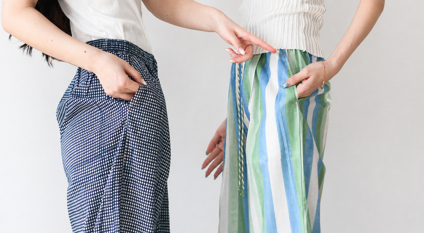 Two pairs of pants, one checkered and one striped, worn by a person on a plain background.
