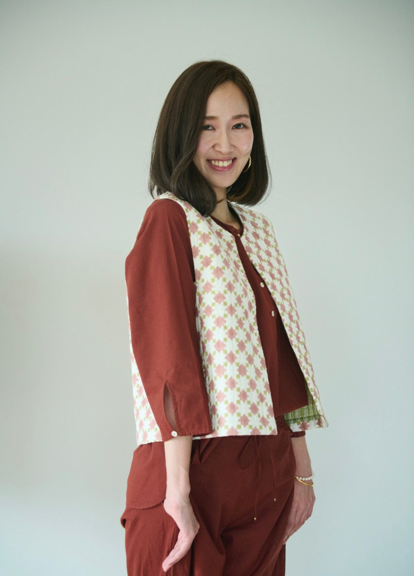 Hand block print quilted vest in apricot and green