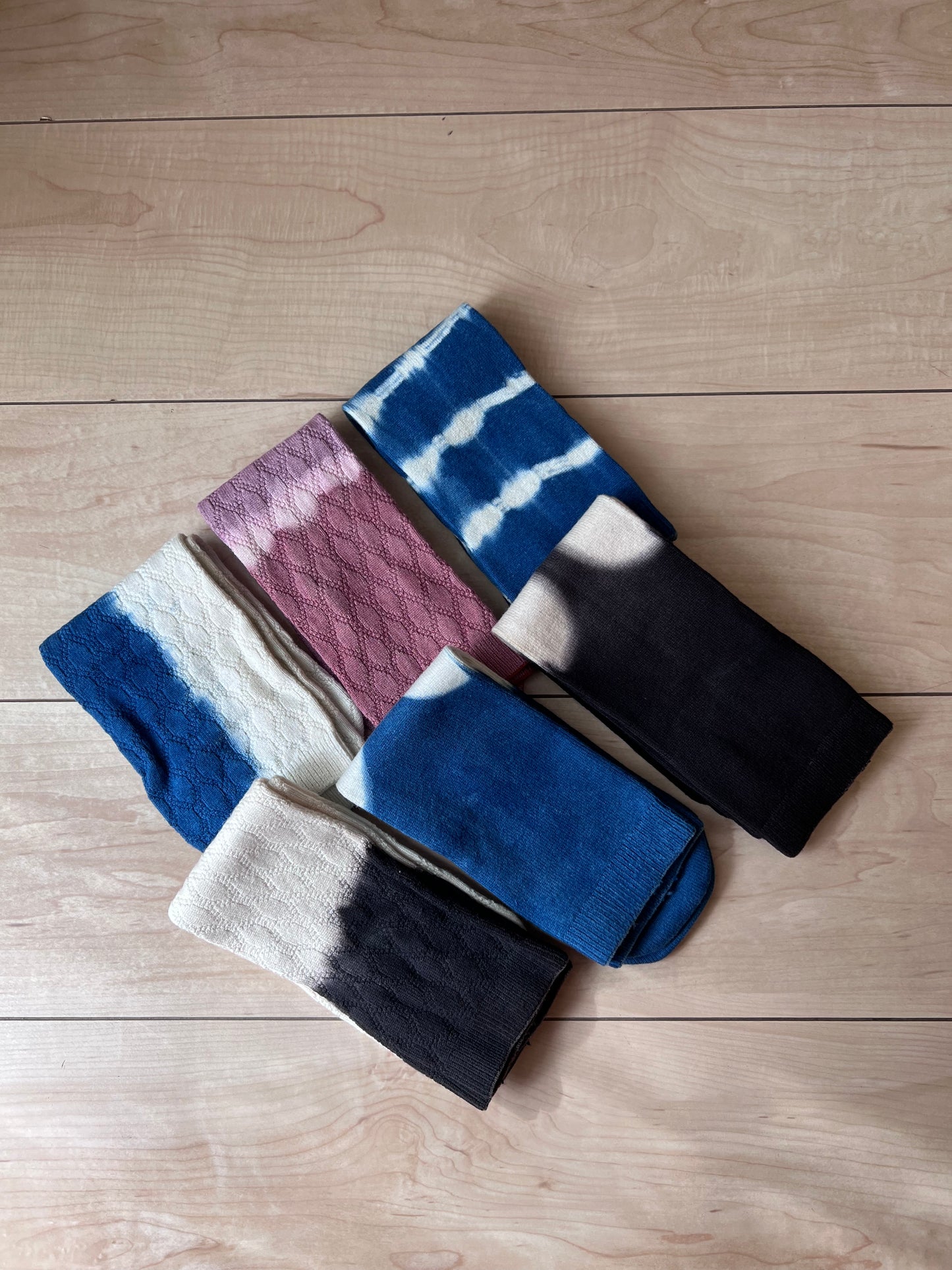 Set of colorful natural dye socks on a wooden surface