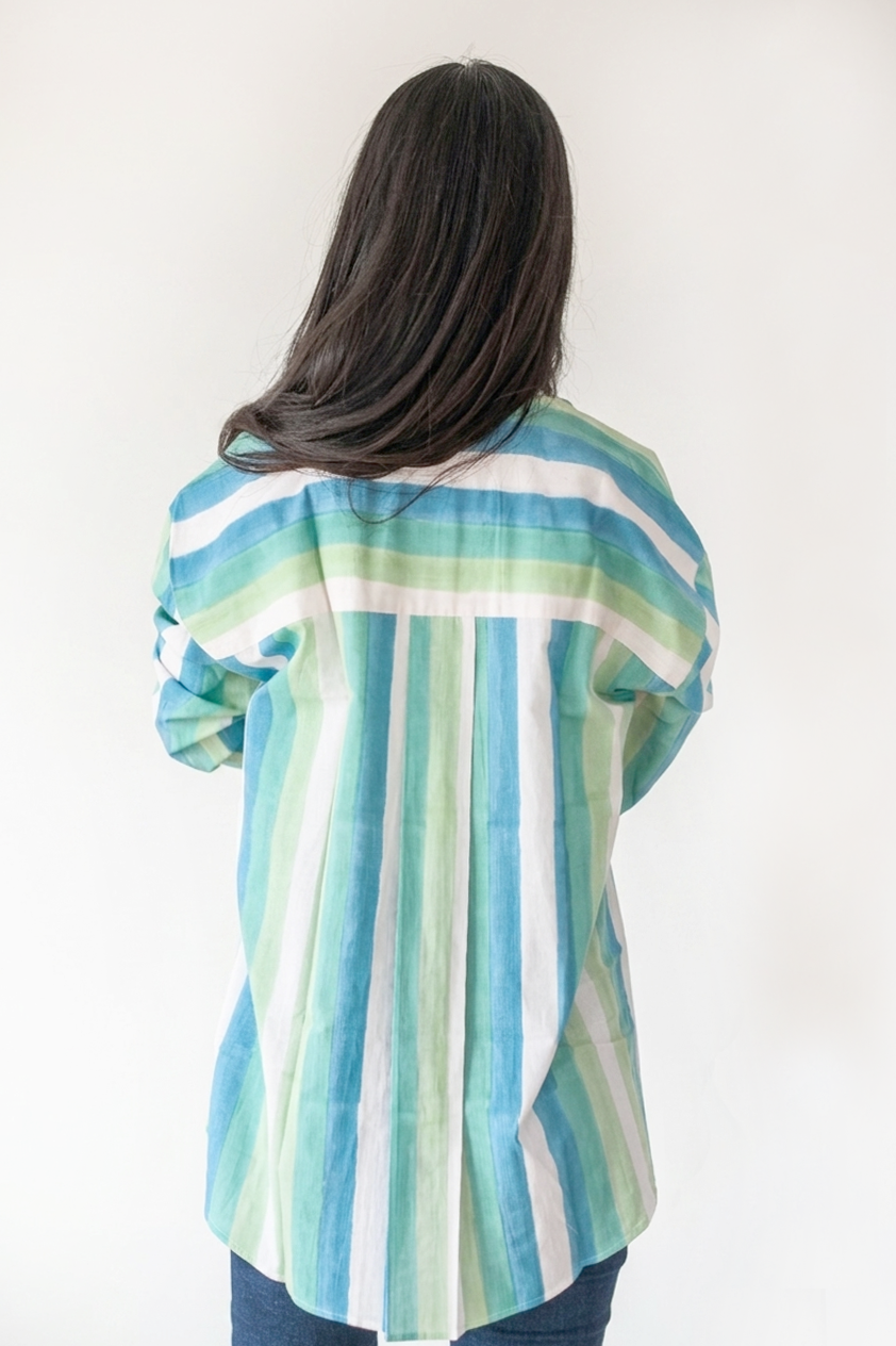 Person wearing a colorful striped shirt with a white background