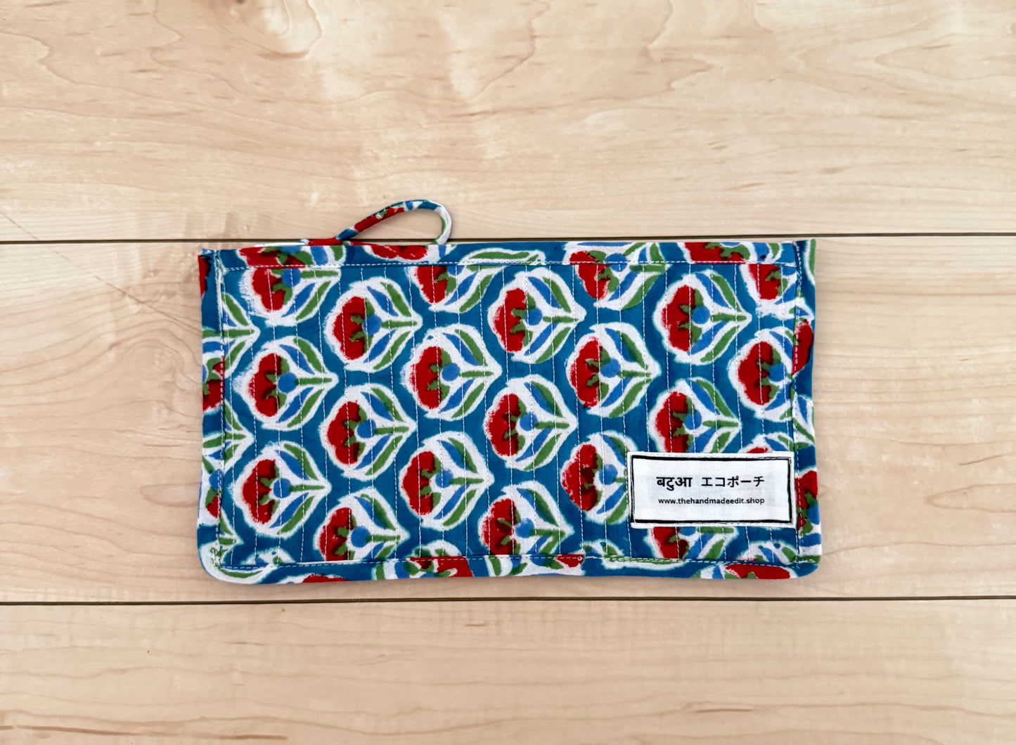 Patterned fabric pouch on a wooden surface