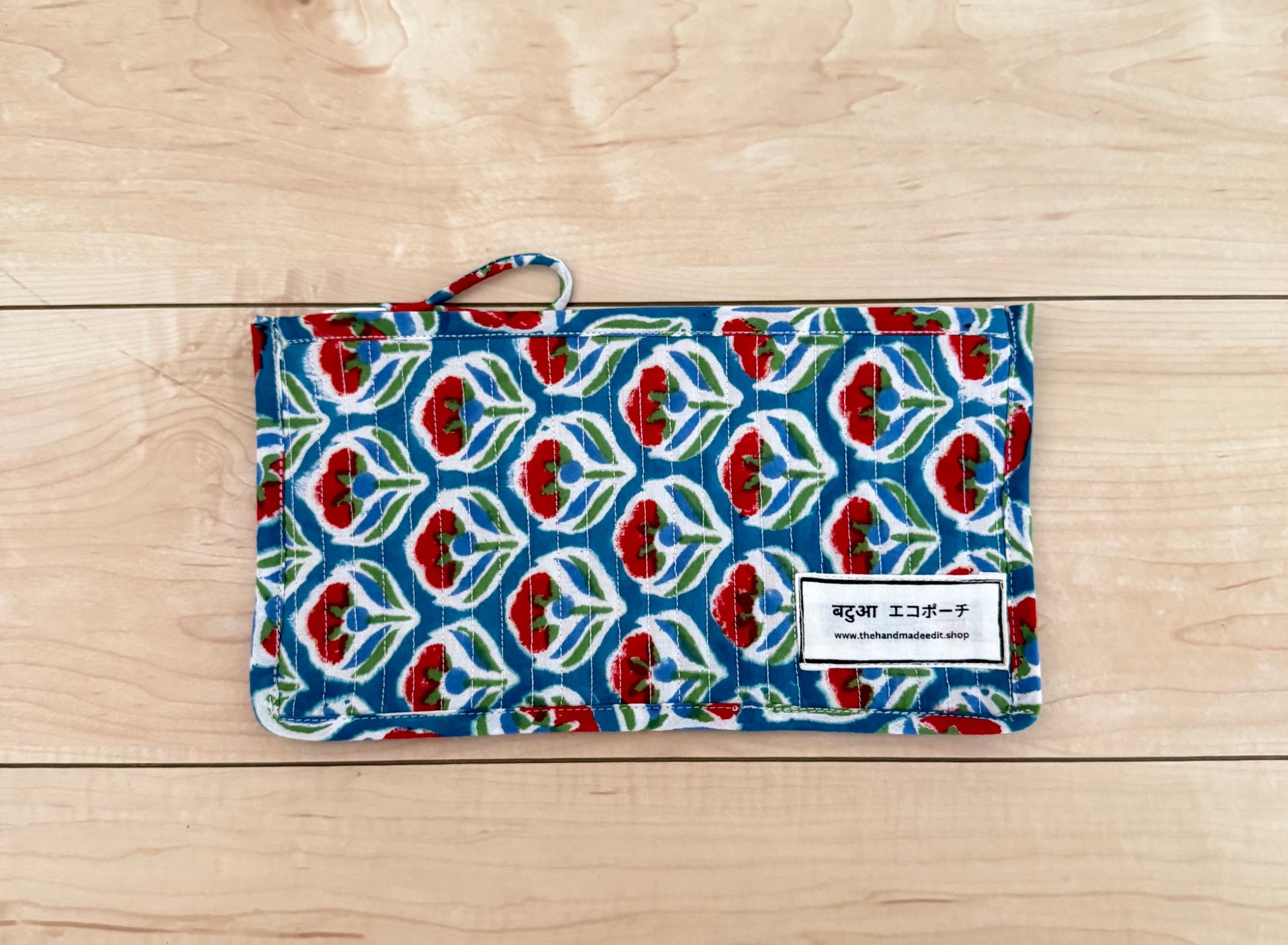 Patterned fabric pouch on a wooden surface