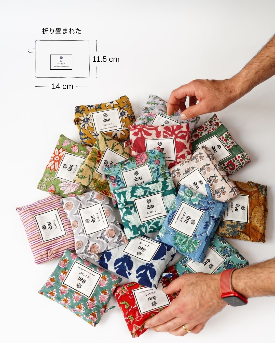 folded Handmade cotton eco bags with floral designs and labels on a white surface.