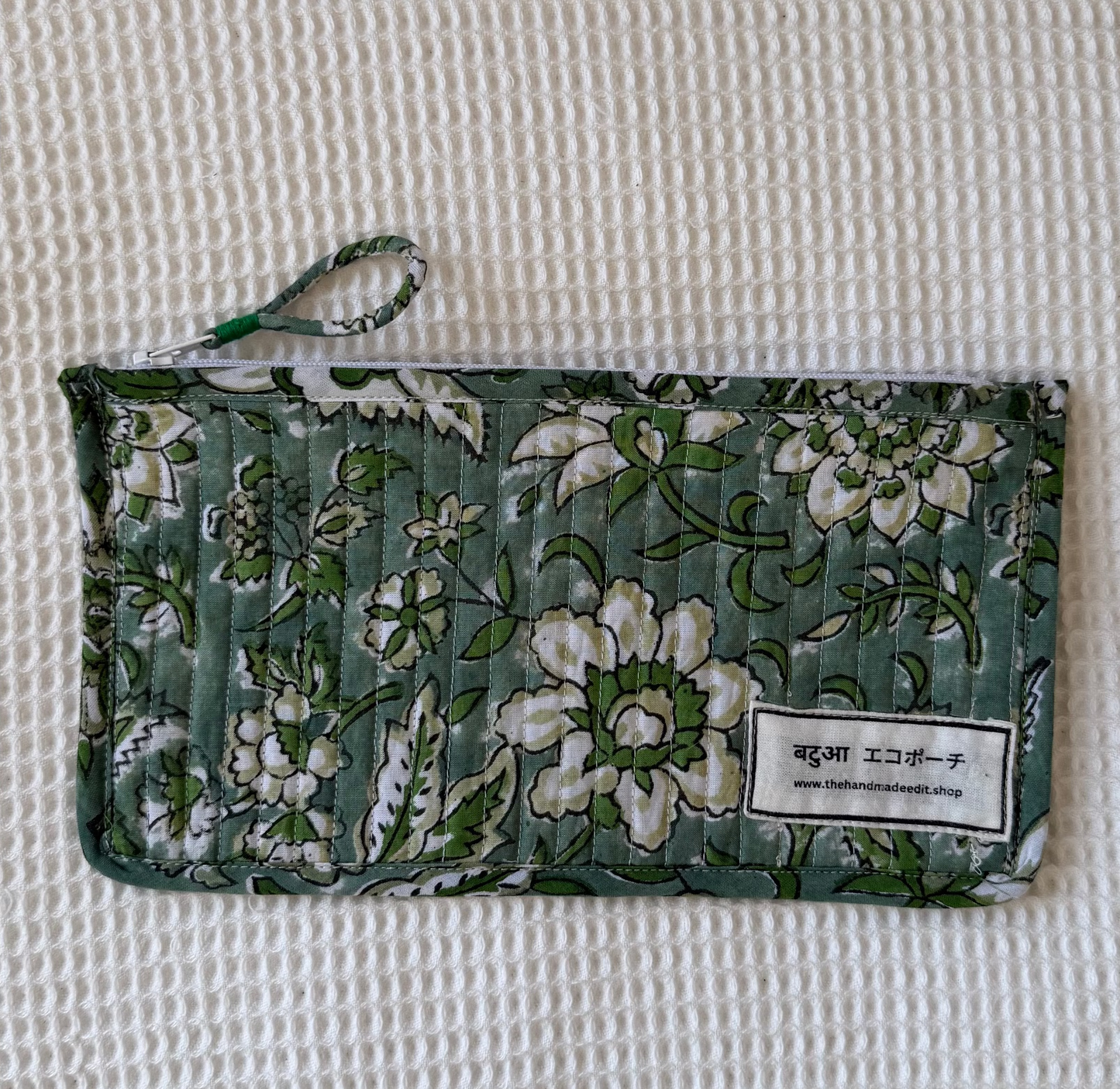 Floral-patterned pouch on a textured surface