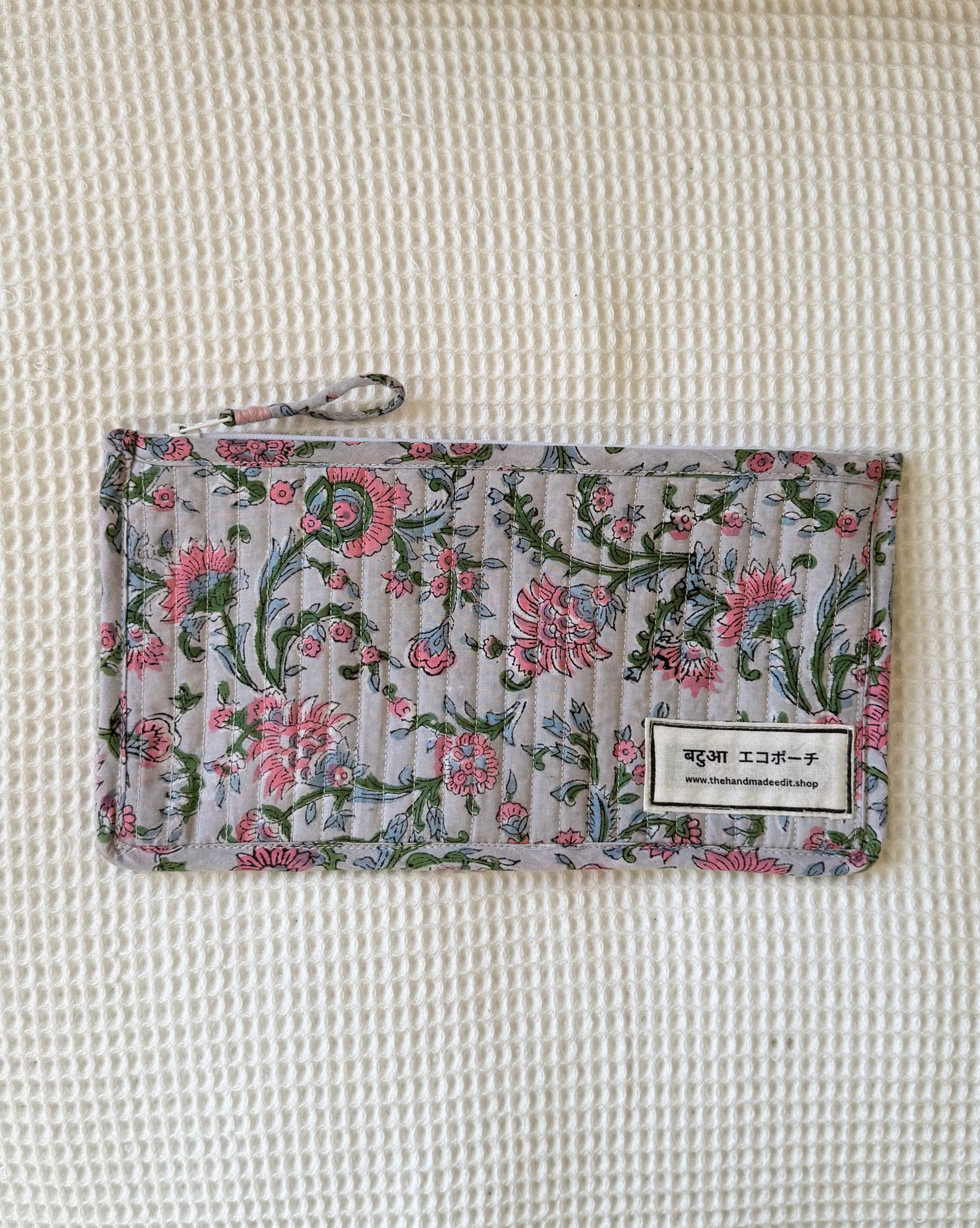 Floral-patterned pouch on a textured surface