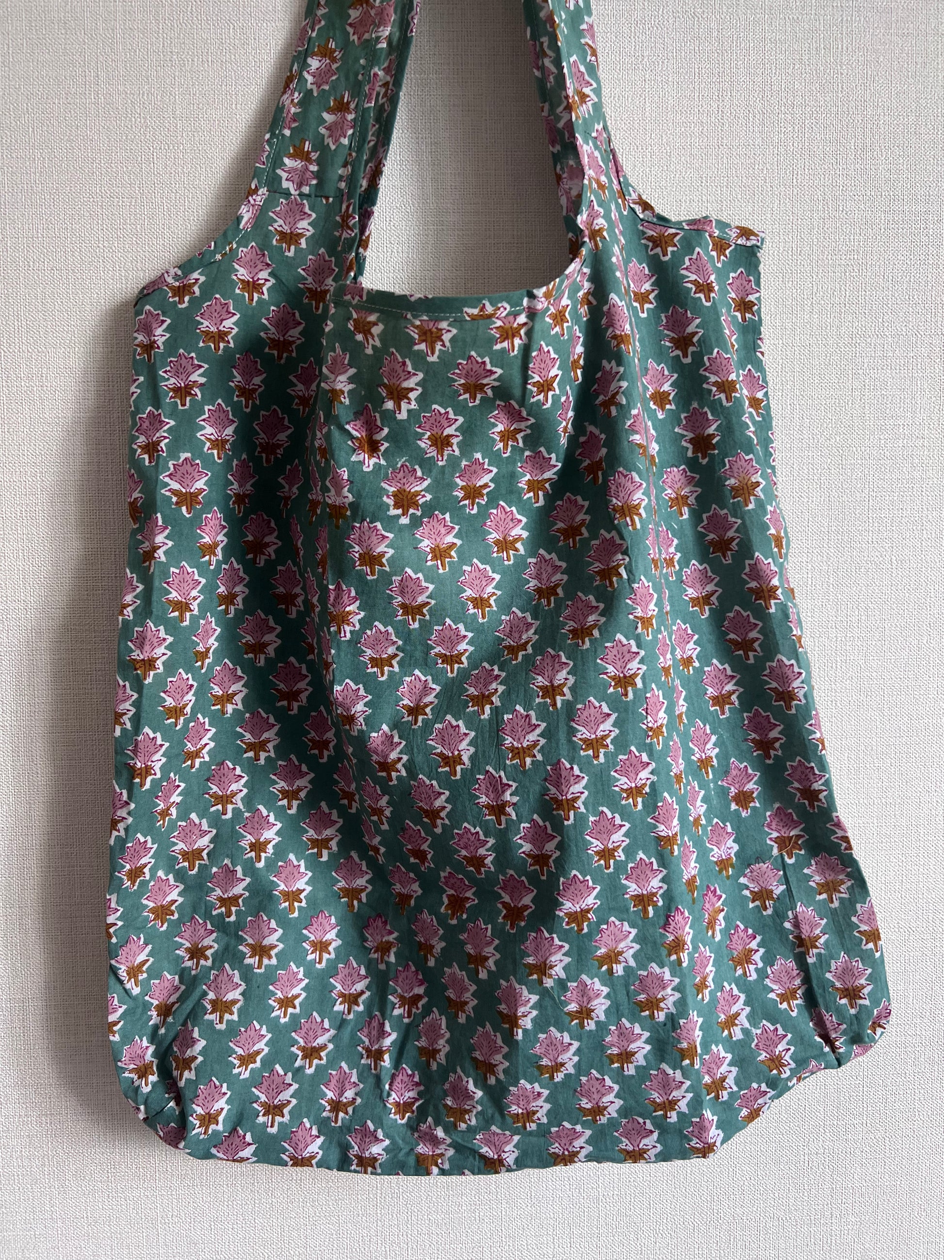 Floral patterned cotton reusable bag on a light background