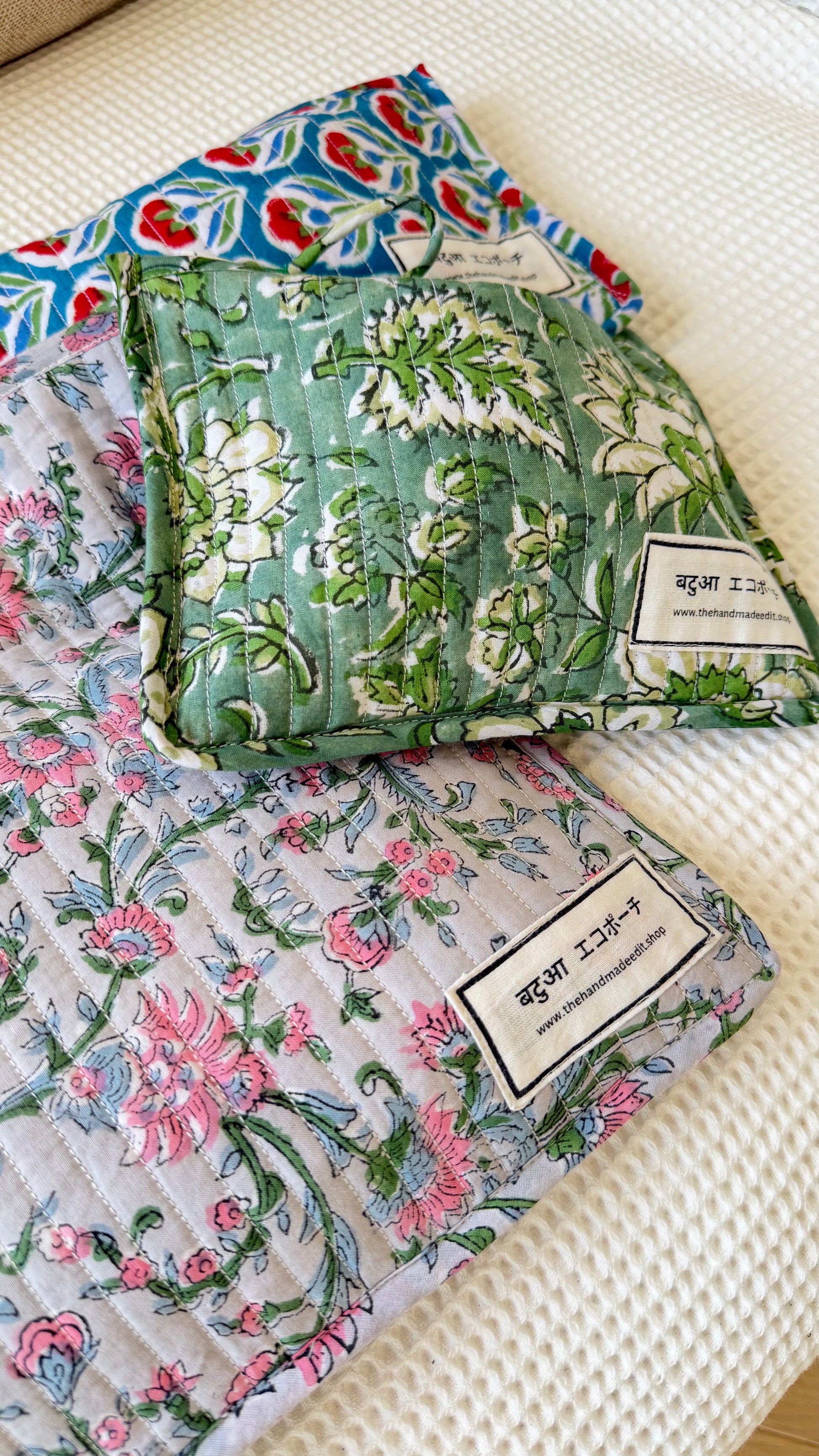 floral-patterned fabric pouches on a textured surface