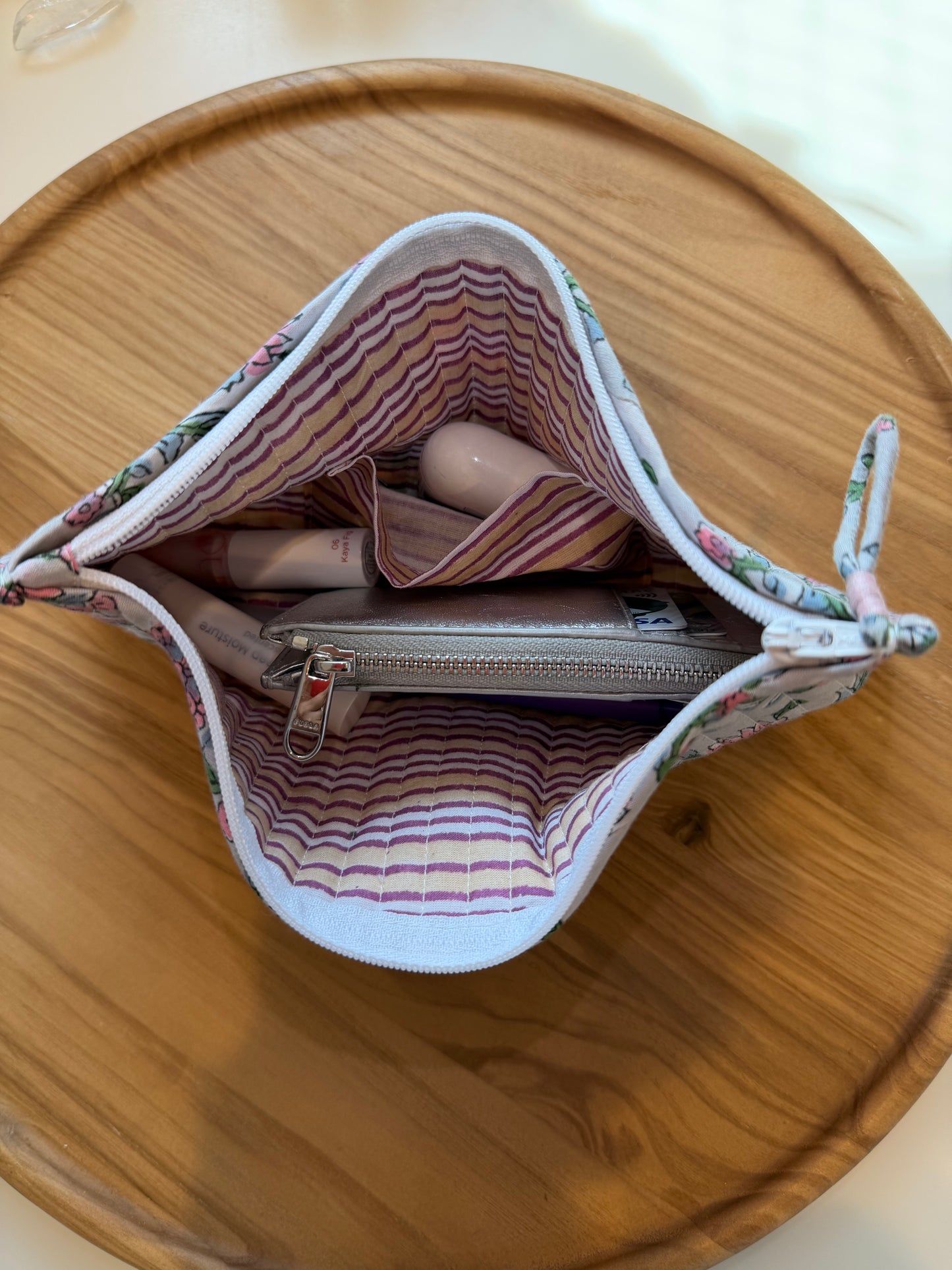 Open fabric pouch with striped pattern on a wooden surface