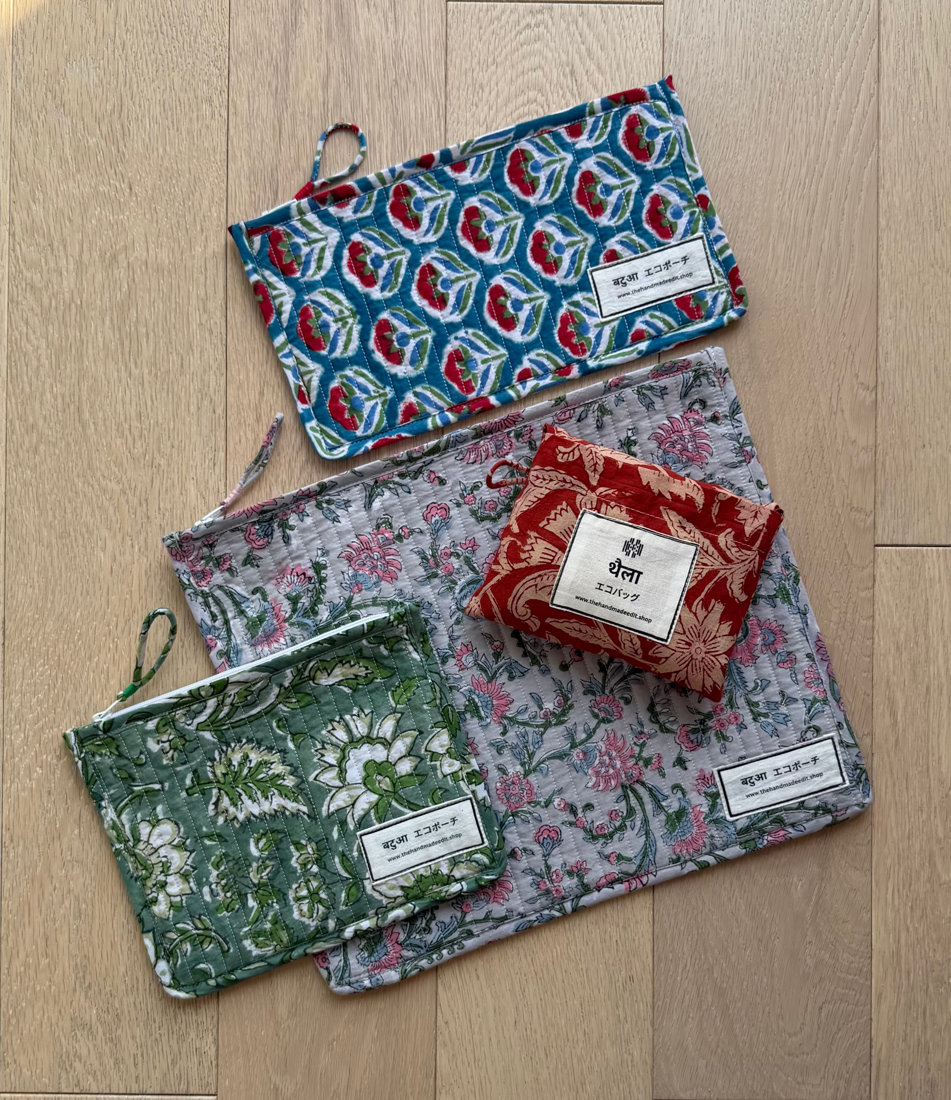 Four patterned pouches on a wooden floor