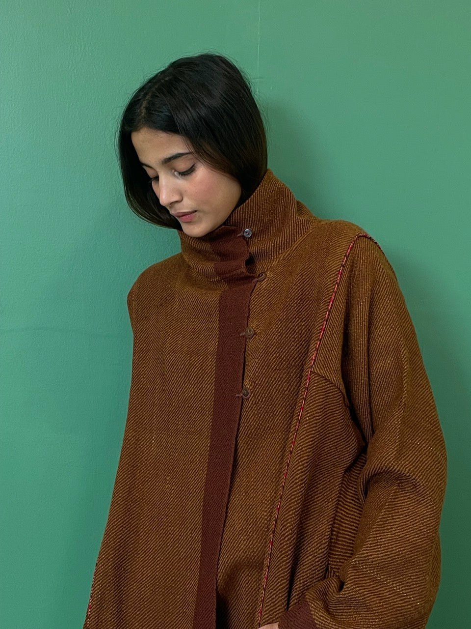 Handwoven rust colour merino wool knee length jacket with contrast detailing