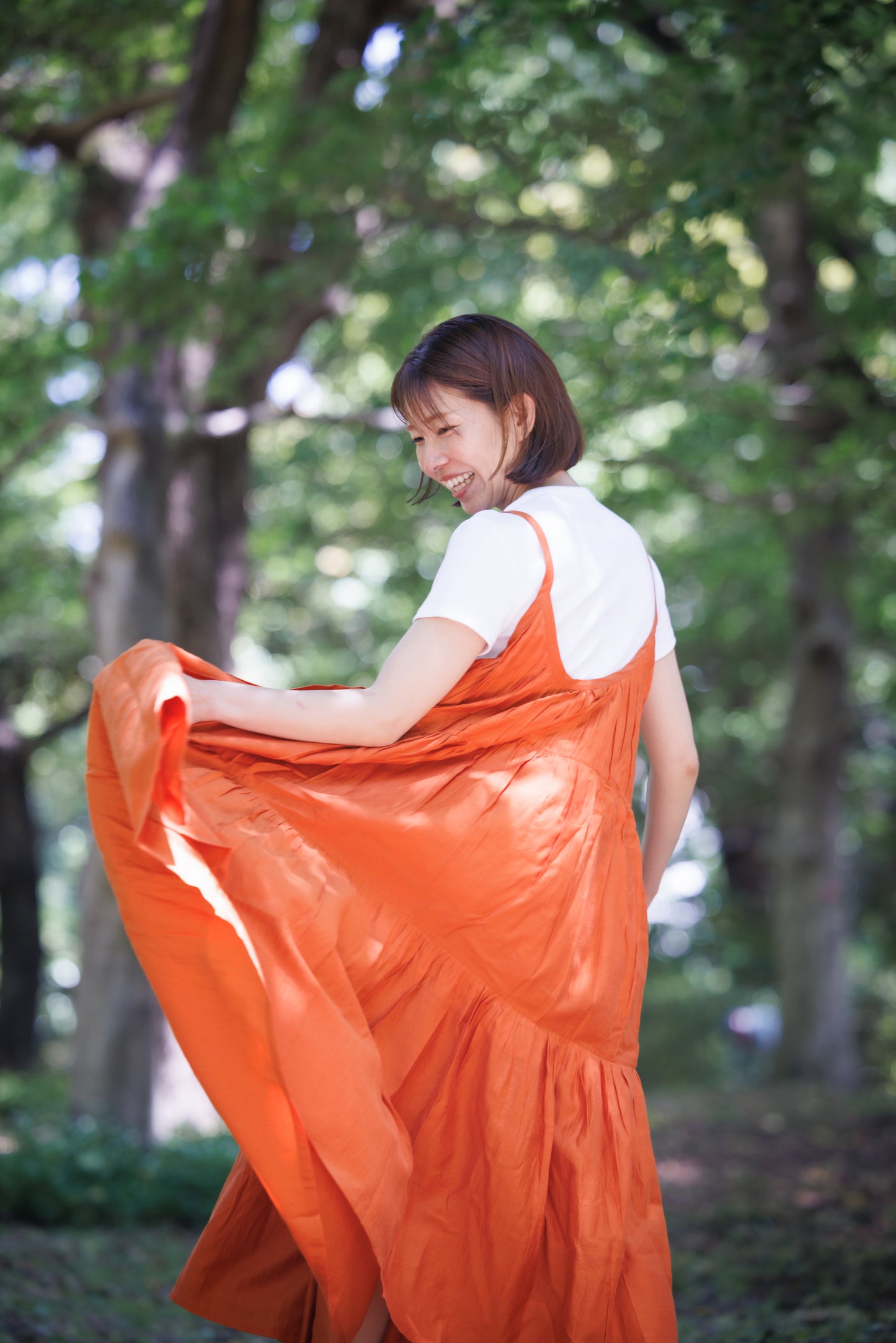 Orange three tier strappy dress with scoop back and large flare