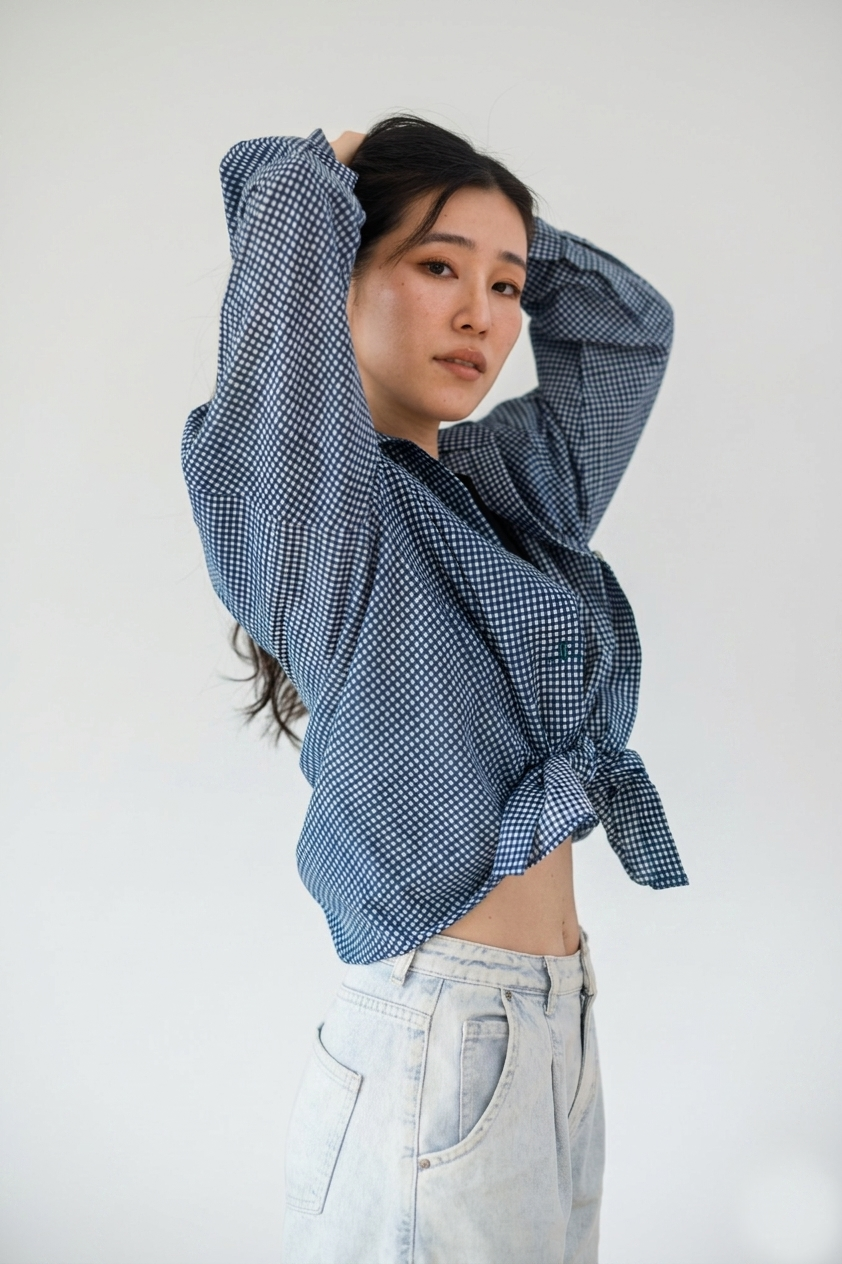 Person wearing a blue checkered shirt with a white background